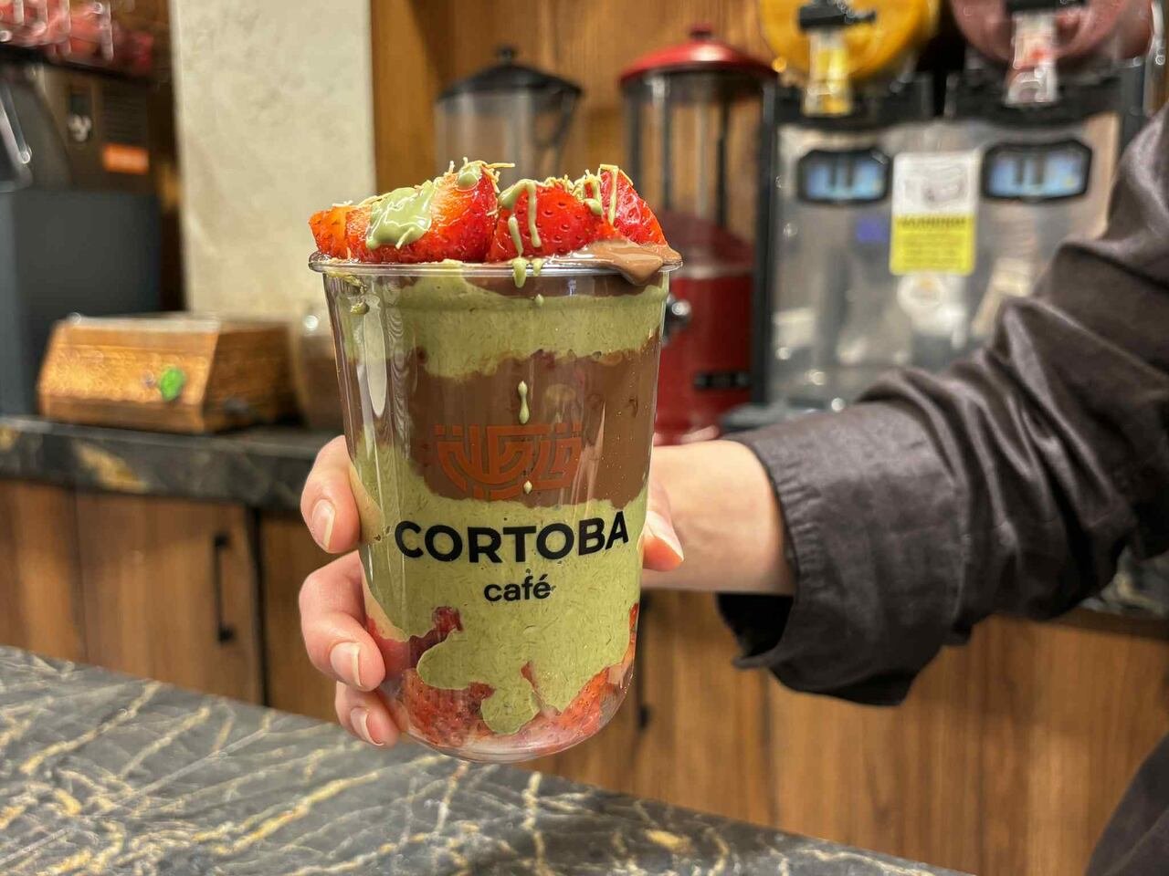 A Dubai chocolate cup, which contains chocolate, pistachio paste and strawberries